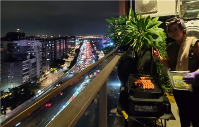 The city lights sparkle as Michelle barbecues some dinner! (Photo: Michelle Chiang)