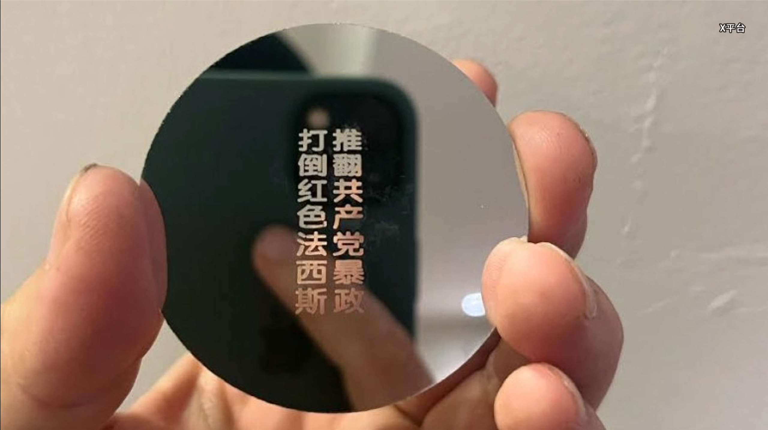 Chinese protestor uses project lens to cast anti-Communist slogans on a high-rise for 50 minutes.