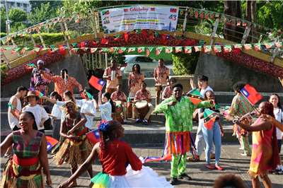 Performers and attendees dance and wave flags at a celebration marking 43 years of diplomatic relations between Taiwan and Saint Kitts and Nevis in Taipei on October 16, 2026. (Rti Photo/James Thompson)
