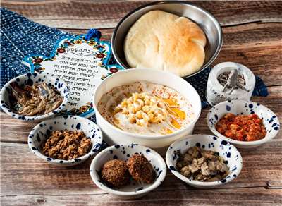 Hummus, a chickpea paste that is very popular in Israel and throughout the Middle East, is seen here served at LoraCorlo with a side of pita bread & with different toppings for your choice. (Photo: Dan Orlovsky)