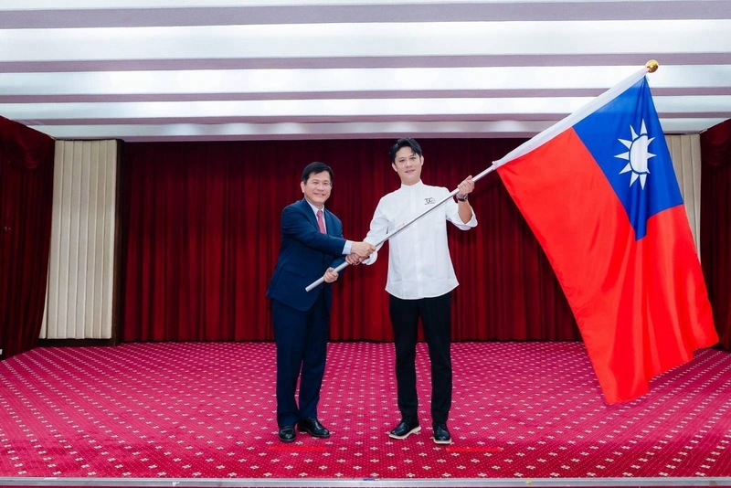 Foreign Minister Lin Chia-lung (left) presented the flag to the head of the Taiwan Junior Young Chefs Association delegation (right) on the 17th, wishing the delegation success as they travel to Malaysia to participate in the 5th Global Culinary Challenge Malaysia Tour. (Photo: CNA)