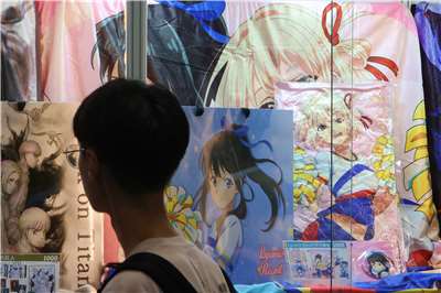 A visitor looks at merchandise on display at the 25th Comic Exhibition in Taipei on July 23, 2026. (Rti Photo/James Thompson)