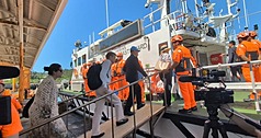 IPAC delegation members board a Coast Guard vessel on July 9. (Photo: CNA)