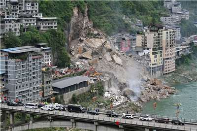 The landslide occurred at approximately 9 a.m. on July 17 in a populated area, destroying several buildings along the hillside and pushing earth and debris into the adjacent Wujiang River. (Photo: Reuters)
