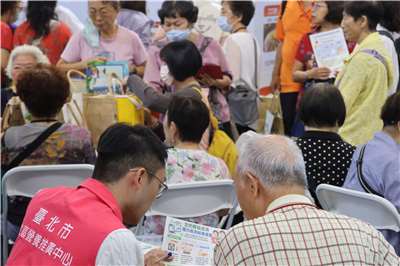 A visitor receives health-related information at the third Healthy Ageing Tech Show in Taipei on August 7, 2026. (Rti Photo/James Thompson)