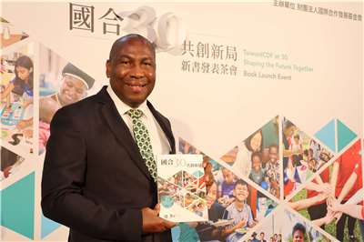 Saint Lucia Ambassador to Taiwan Robert Kennedy Lewis holds a copy of Taiwan ICDF’s 30th anniversary book at its launch event in Taipei on August 14, 2026. (Rti photo/James Thompson)