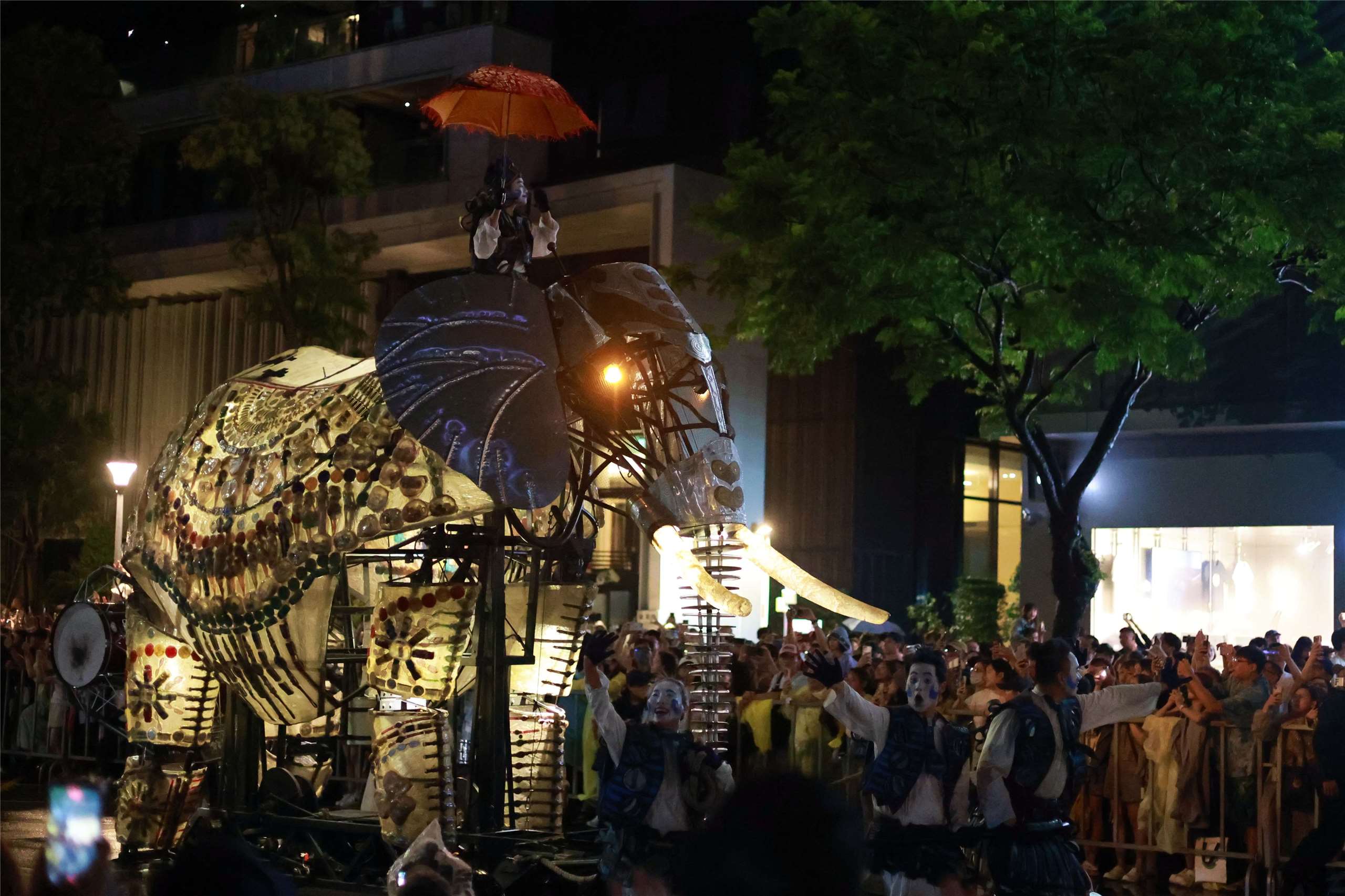 A performer rides atop one of the giant mechanical elephants as crowds watch “The Elephants Are Coming” in Taipei on September 6, 2026. (Rti Photo/James Thompson)