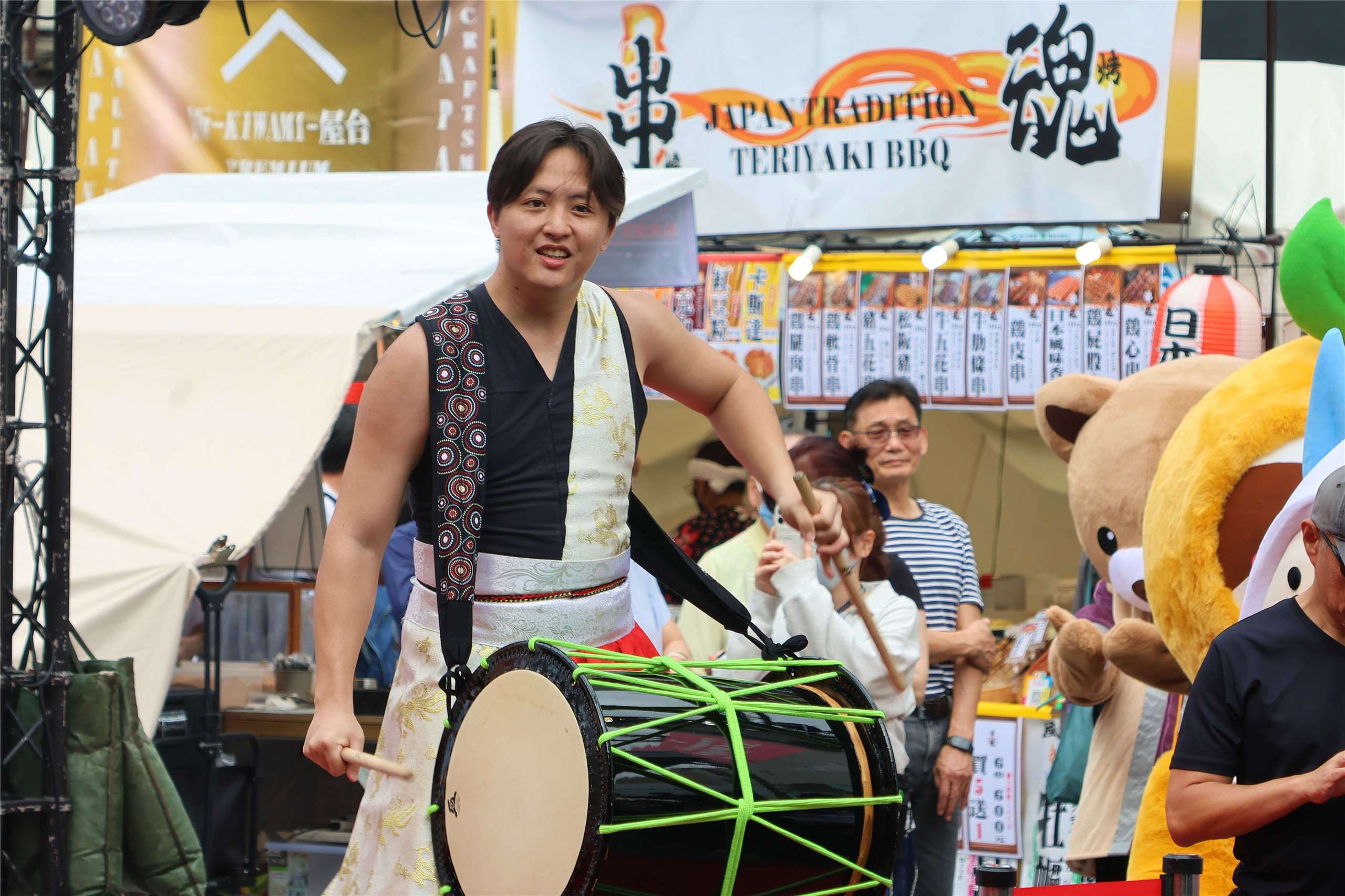 A performer hits a drum at the “Taipei Xinzhongshan Linear Park Food and Travel Festival” in Taipei on May 15, 2026. (Rti Photo/James Thompson)