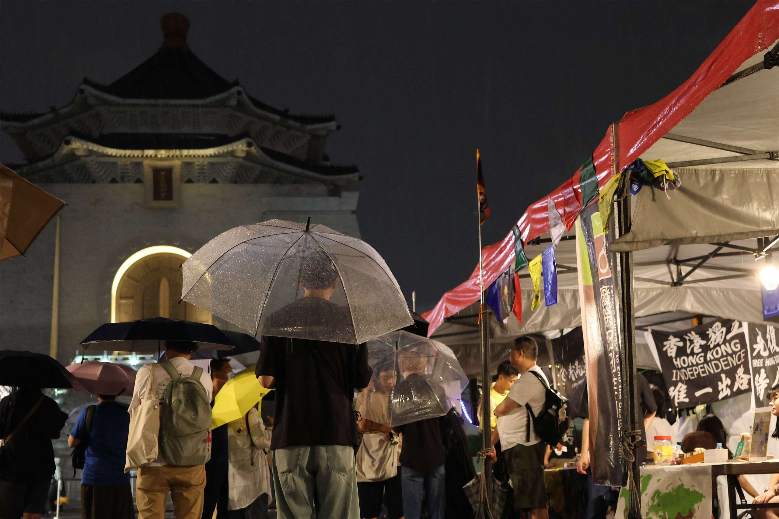Attendees stand near stalls set up by NGOs and political groups in Liberty Square in Taipei during a vigil marking the 37th anniversary of the Tiananmen Square Massacre. (Rti Photo/James Thompson)