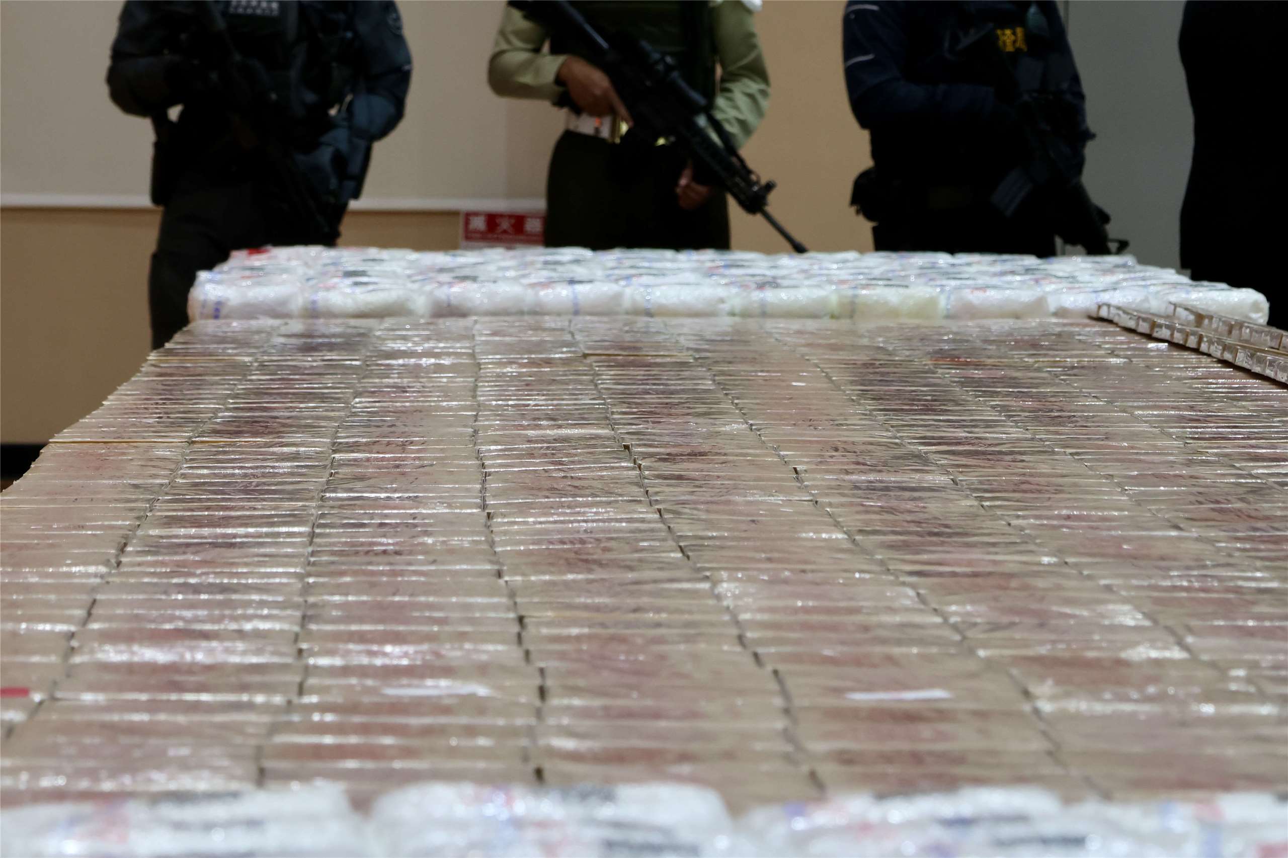 Seized heroin and ketamine are displayed under armed guard at a news conference in New Taipei City on June 16, 2026. (Rti Photo/James Thompson)