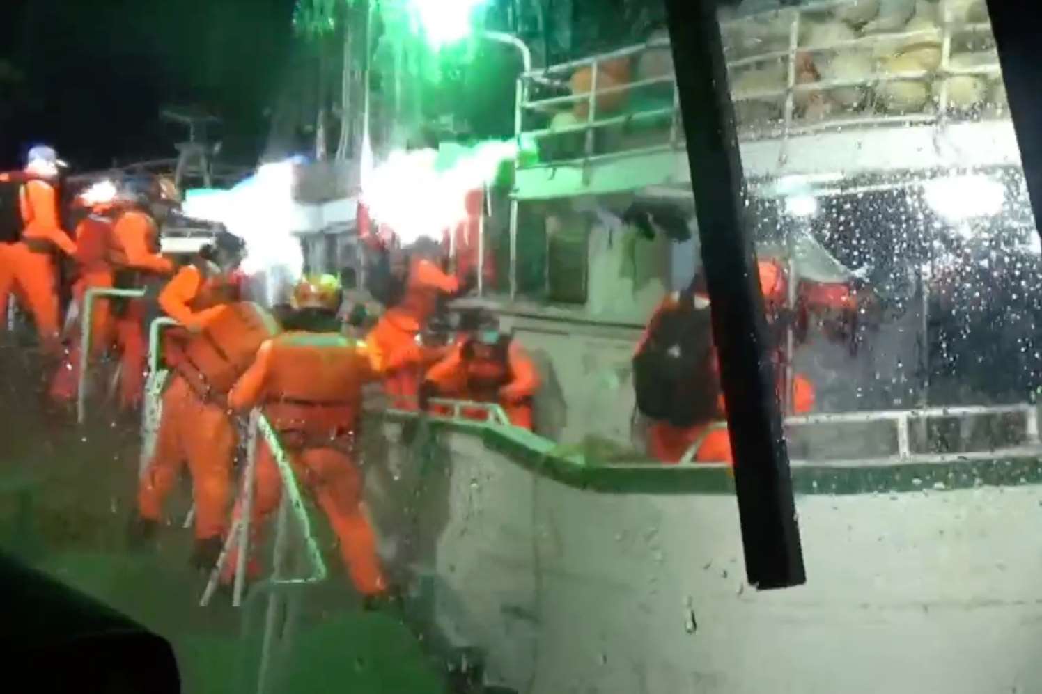 Coast Guard officers jump aboard the Tian Fa Tsair No. 38 in rough seas off Taiwan’s southwest coast on December 3, 2025. (Photo: MJIB/Video screenshot)