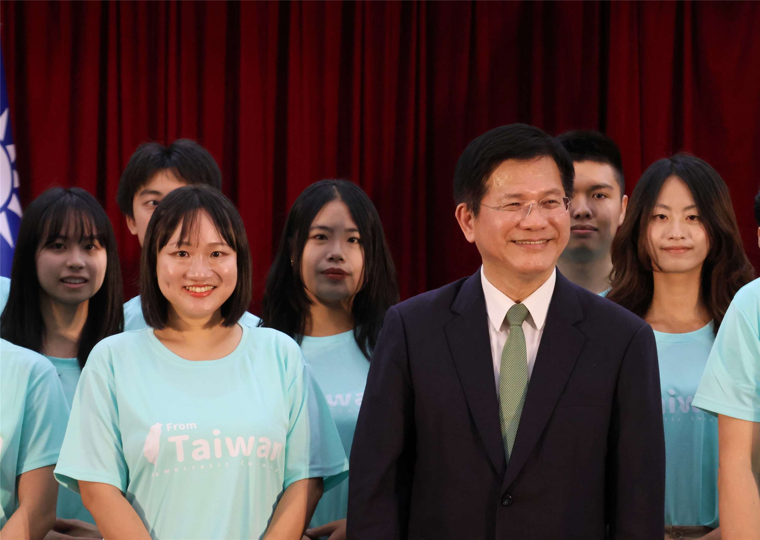 Taiwan ICDF Deputy Secretary General Hsieh Pei-fen, left, and Foreign Minister Lin Chia-lung pose with participants at a send-off ceremony for youth ambassadors in Taipei on August 12, 2026. (Rti Photo/James Thompson)