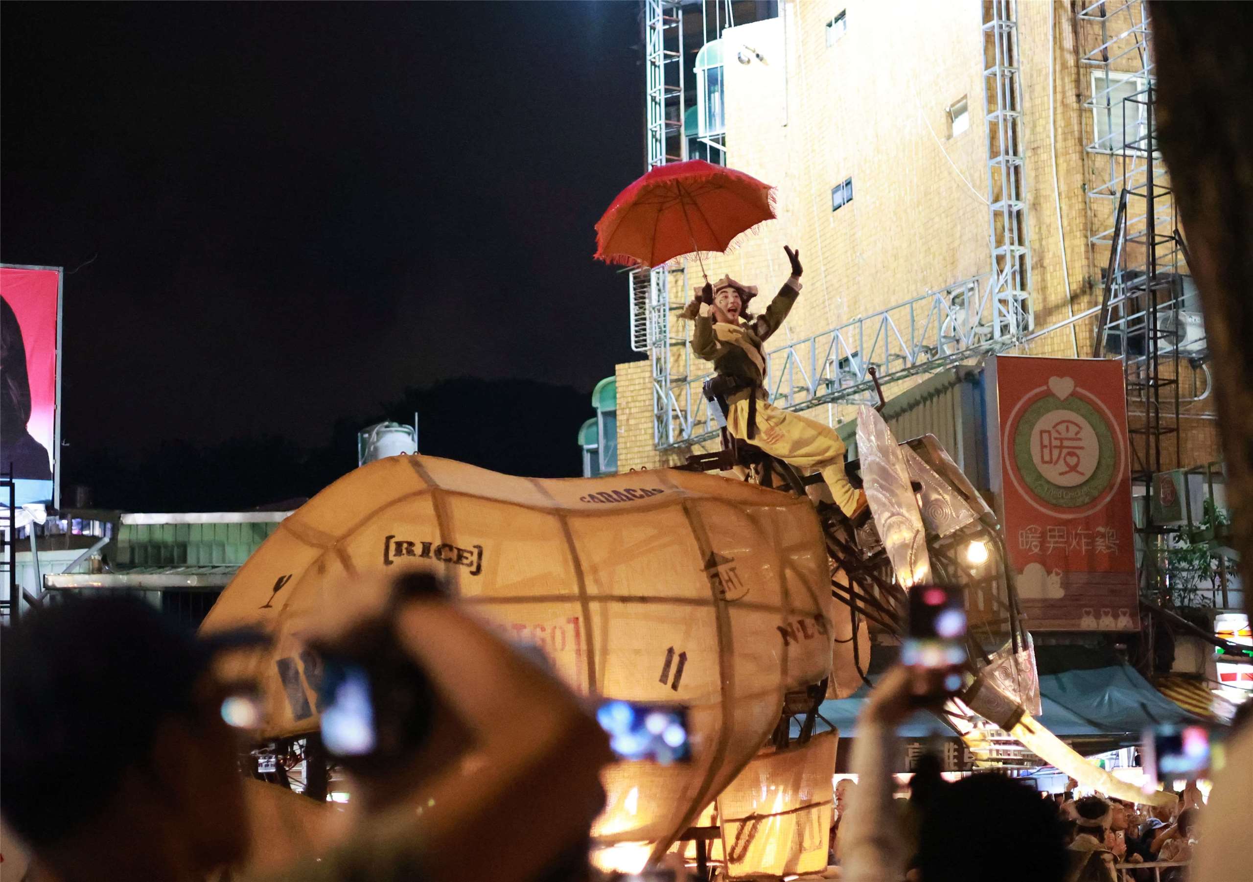 A performer rides atop one of the giant mechanical elephants as crowds watch “The Elephants Are Coming” in Taipei on September 6, 2026. (Rti Photo/James Thompson)