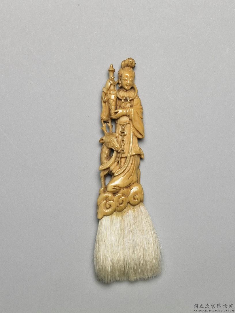 Image 4: Poignée en ivoire décorée d'une divinité présentant une pêche de longévité (source MNP)