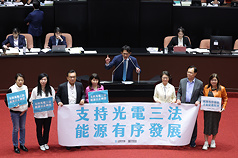 立法院會14日傍晚審理地質法第5條條文修正草案，三讀後發言，民眾黨團總召黃國昌（後中）率黨籍立委於發言台拉起布條，宣布光電3法修正通過。
