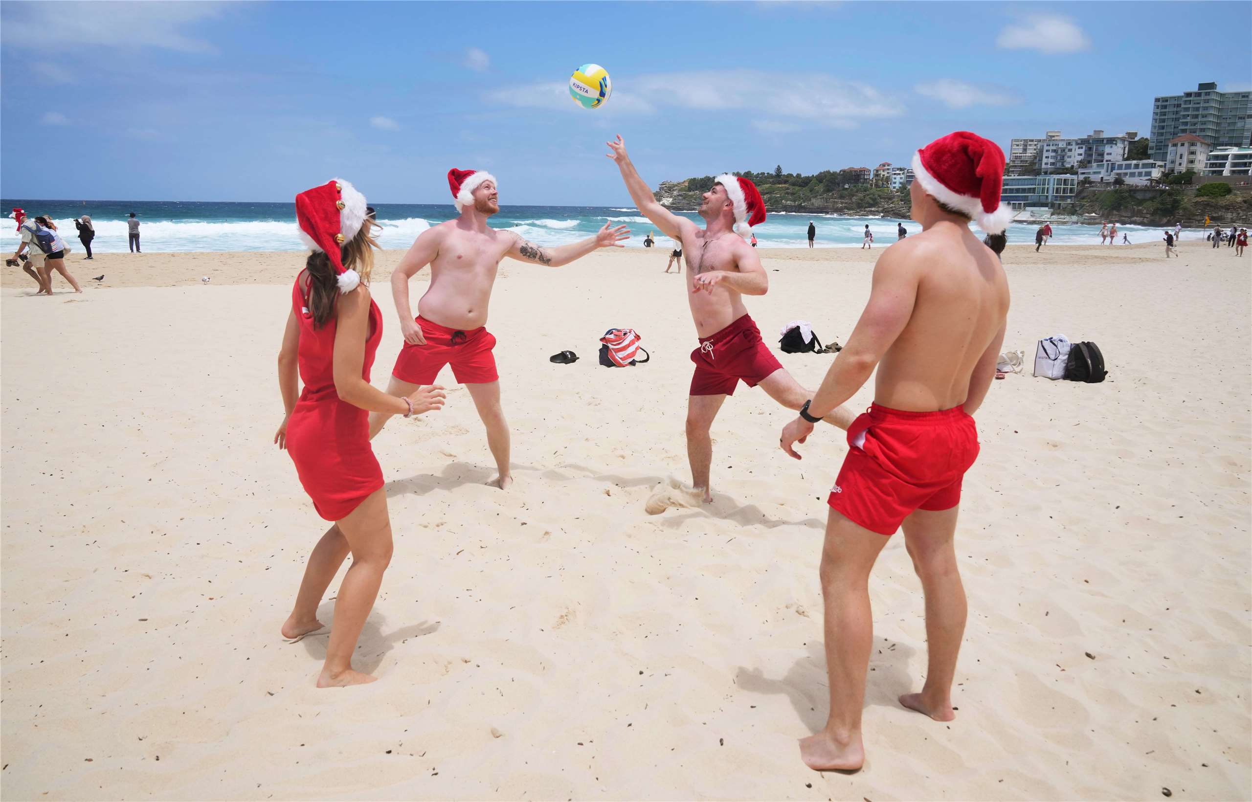 英國遊客25日在澳洲雪梨邦代海灘(Bondi Beach)打排球。