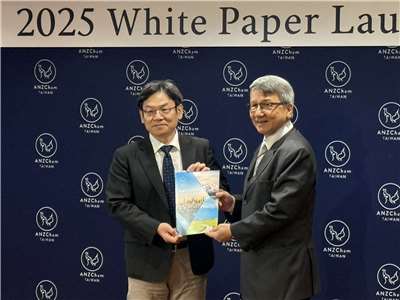 國發會主委葉俊顯(左)自澳紐商會理事長陳明信(右)手中接下今年澳紐商會白皮書。(謝佳興 攝)