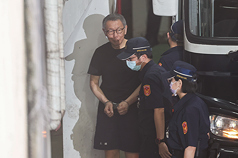 台北地方法院審理京華城案，7日提訊在押的前台北市長柯文哲（左）等被告，柯文哲在法警陪同下步下囚車。
