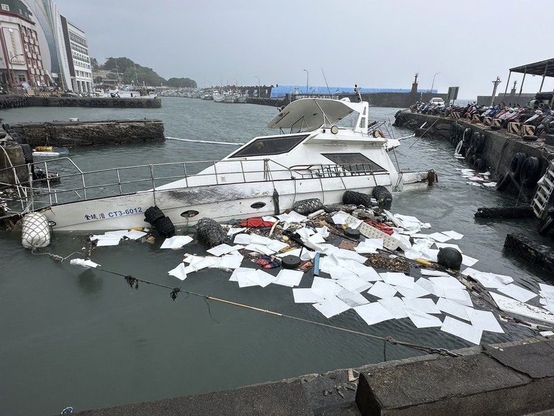 一艘停泊於小琉球白沙漁港的枋寮籍漁船，因23日晚間受強浪衝擊斷纜漂流，致船身破損，隔日凌晨進水下沉。海巡人員設攔油防線防止油污擴散。（海巡署南部分署第五岸巡隊提供）
