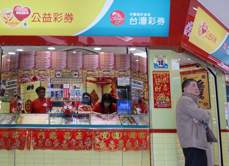 農曆春節假期展開，台北市西門町商圈15日午後人潮多，彩券行工作人員準備好各種刮刮樂款式，讓民眾試手氣。
