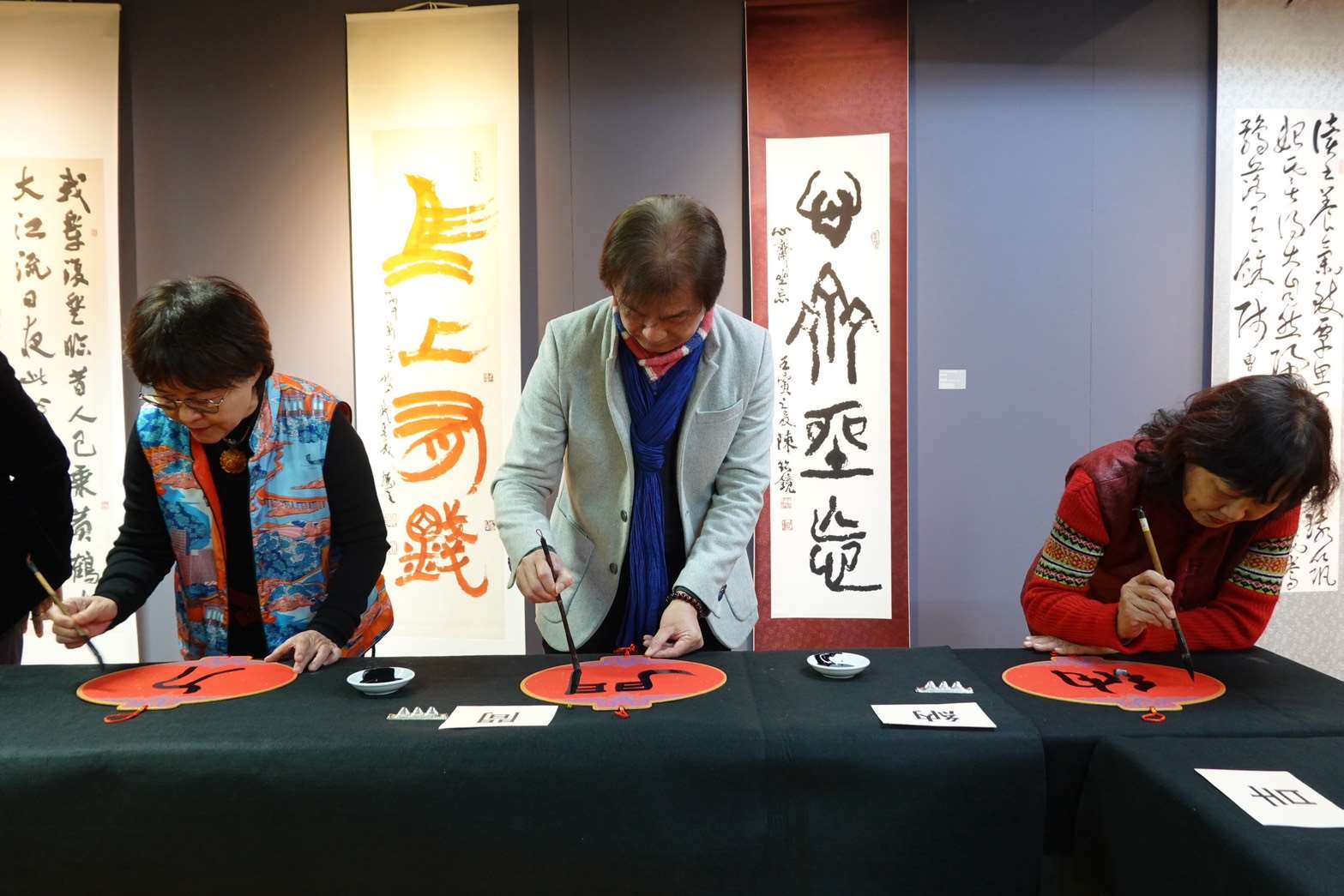 華梵大學舉辦「迎春書法名家邀請展」，多位書法家在開幕式上一同寫春聯。(華梵大學提供)