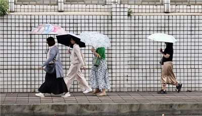 受東北季風影響，今天整體降雨雖趨緩，不過水氣仍多，北部、東半部地區雲量偏多，宜花有較大雨勢。圖為台北市博愛特區民眾街頭撐傘。 (圖：中央社)