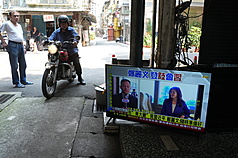 國民黨主席鄭麗文10日在北京人民大會堂東大廳與中共總書記習近平會面。圖為台北市萬華區民眾關注相關新聞。