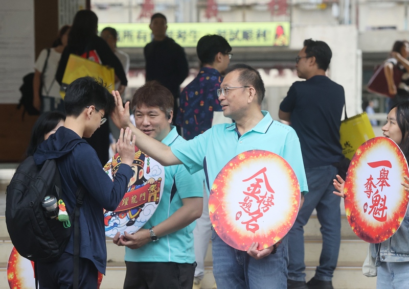 國中教育會考16日登場，共有18萬2千多人報名。台北一處考場內，師長們為進入考場的考生加油打氣。