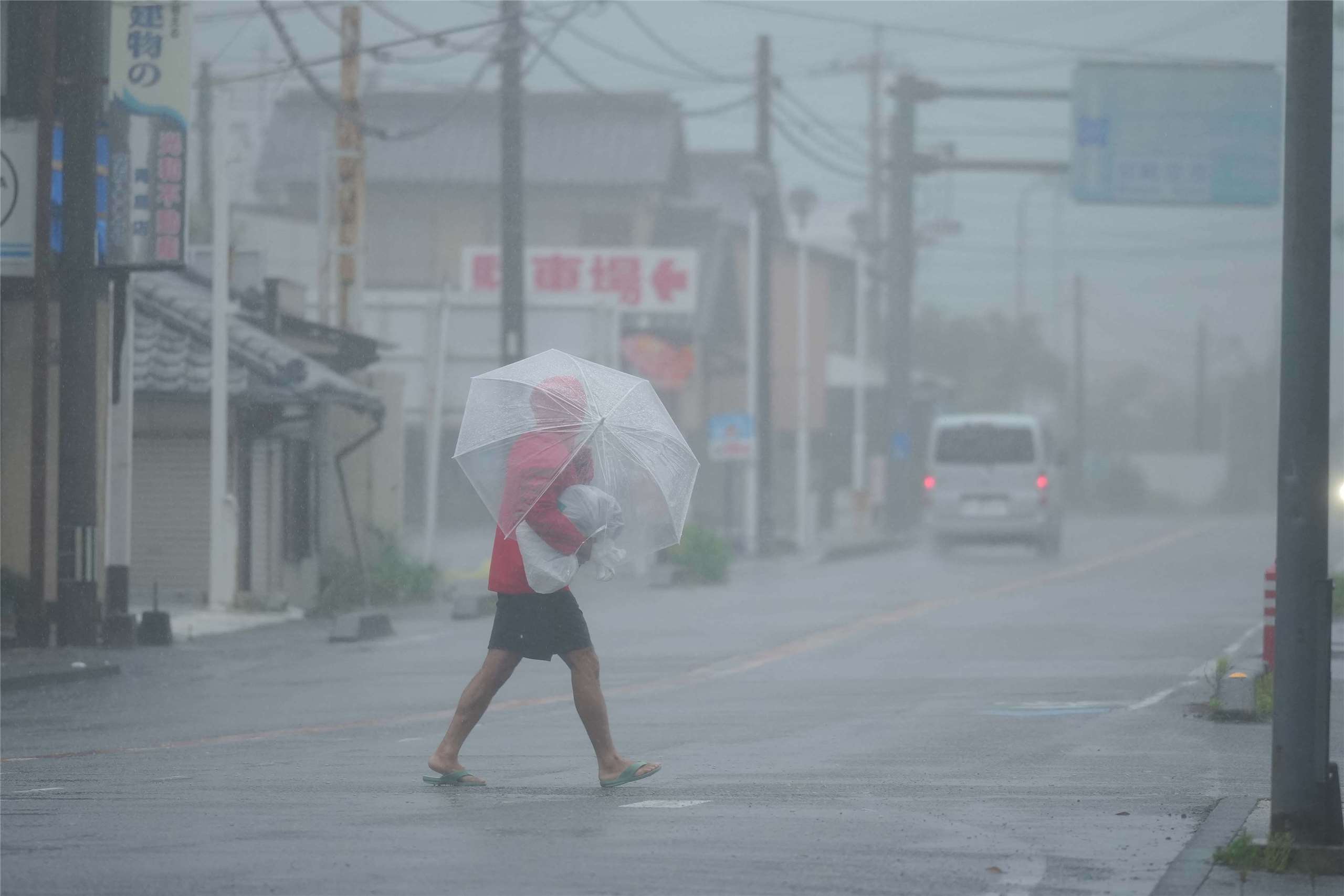 颱風薔蜜(Jangmi)1日在侵襲沖繩(Okinawa)後持續朝北前進，已從颱風下修為暴風雨，日本氣象廳仍針對長浪、土石流和水災示警。圖為宮崎市一名男子在強烈風暴雨中行走。