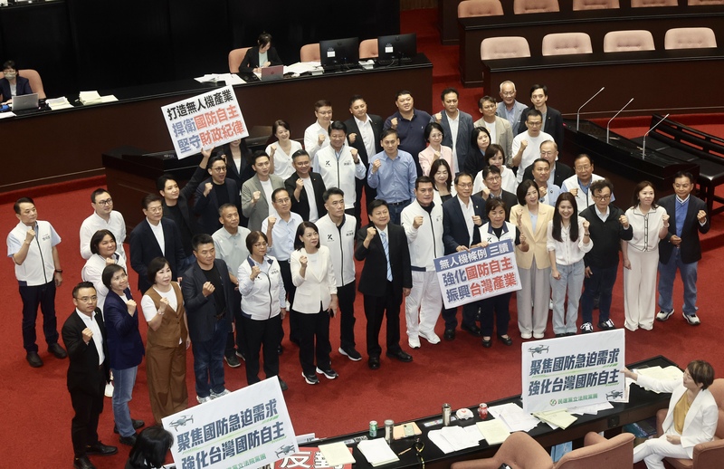 立法院會27日三讀通過「強化國防自主暨無人載具產業發展條例」，國民立院黨團齊聚在議場中舉牌、振臂表立場，強調「強化國防自主、振興台灣產業」等。