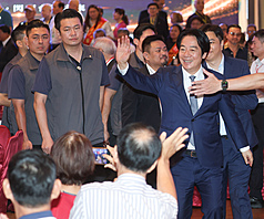總統賴清德(前右)7日晚間在台北出席全國產職業總工會115年度全國模範勞工慶祝晚宴，離場前向與會者親切揮手致意。