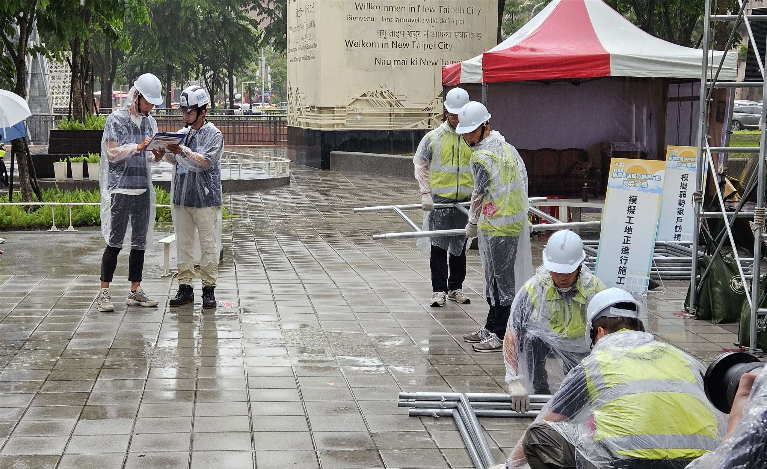 全國首度複合型高溫實兵演練3日在大雨中登場，實地演練戶外勞工熱傷害的現場救護。(劉品希 攝)