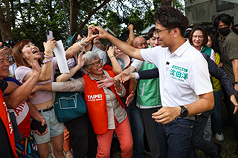 台北市葫蘆堵海光宮25日舉辦中秋搏餅活動，民進黨台北市長參選人沈伯洋(前右)出席，受到民眾熱烈
歡迎。