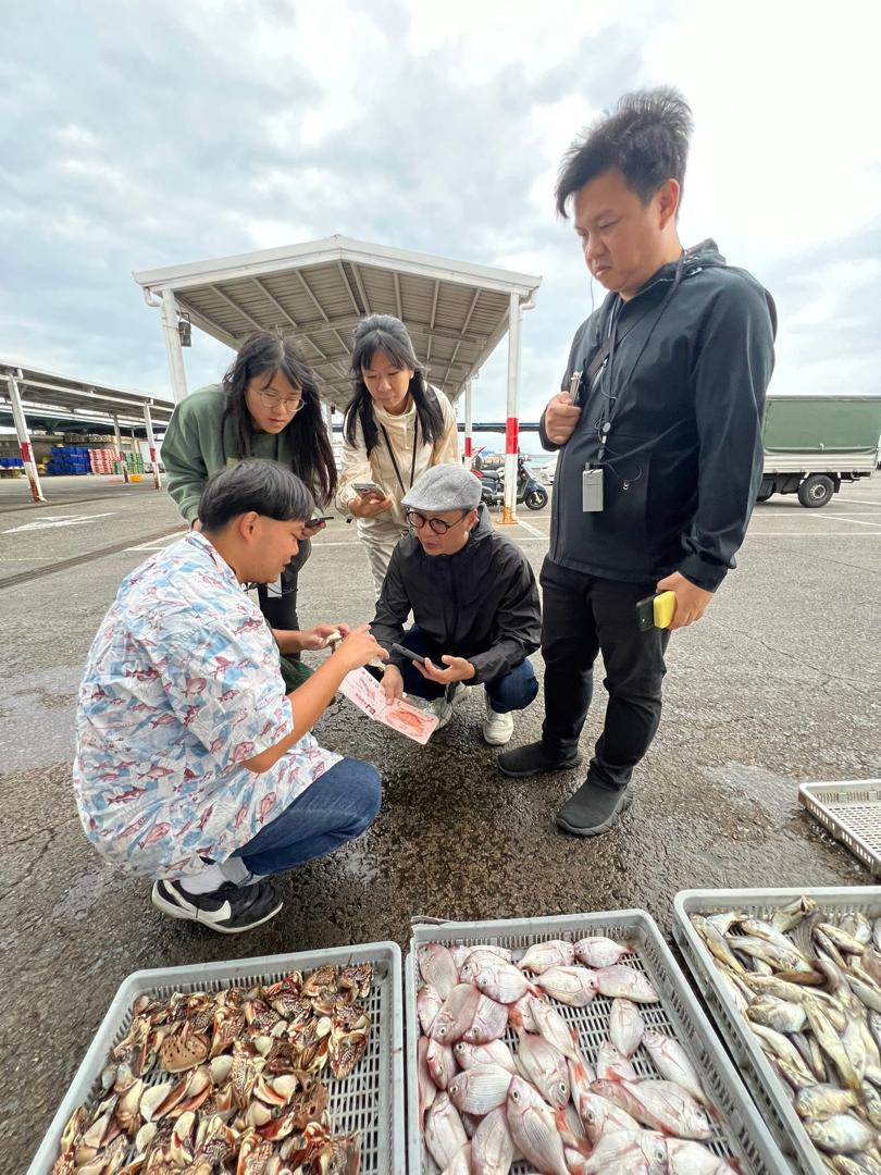莊立康（右2）到澎湖交流時，當地食魚教育團隊年年有鰆帶領參觀魚市場。(莊立康提供)